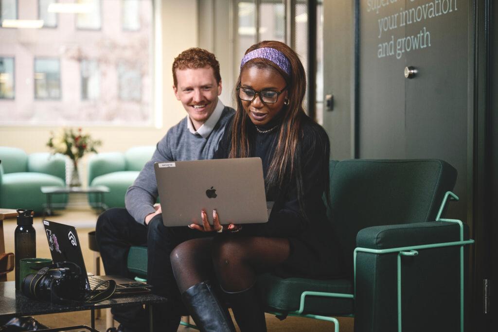 A man and woman working on laptops.