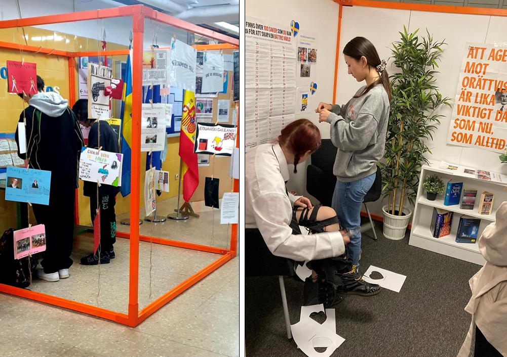 An orange metal cube decorated by students. 