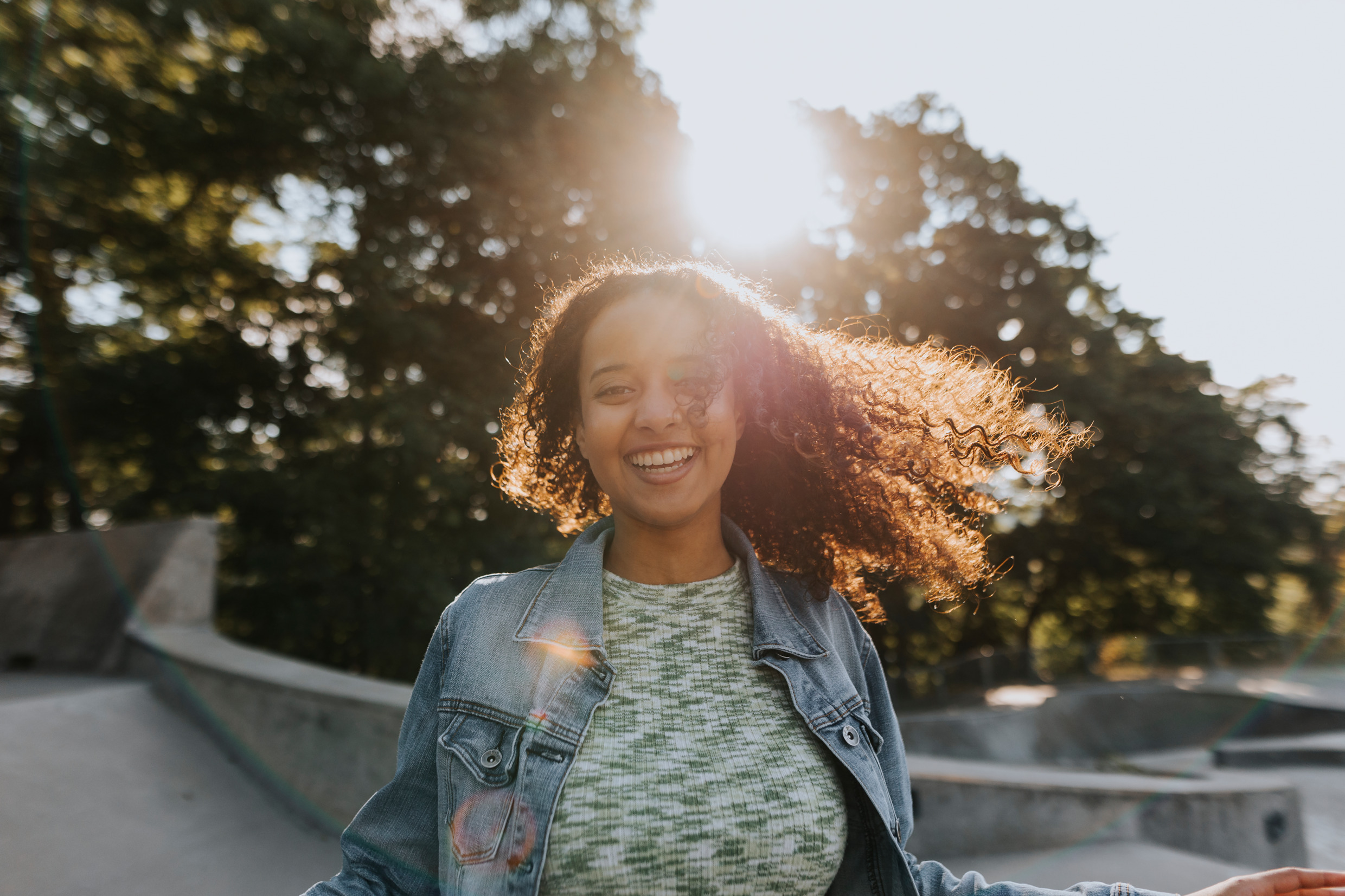 Portrait of a young, happy girl in a skate park.