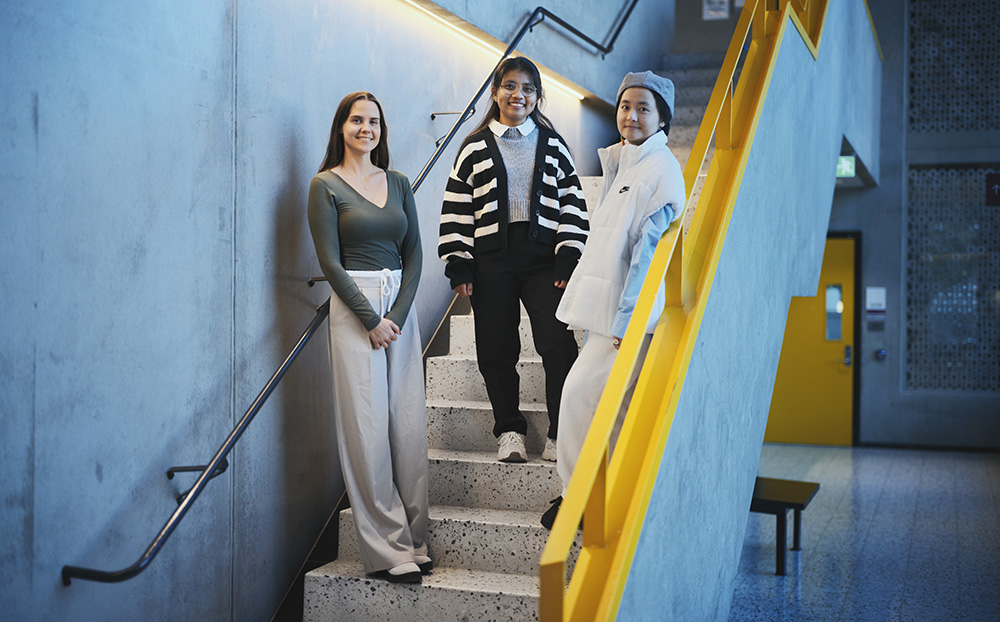 Students in a blue and yellow staircase.