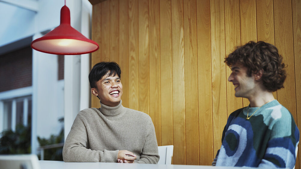 Two students talking in a Swedish university café.