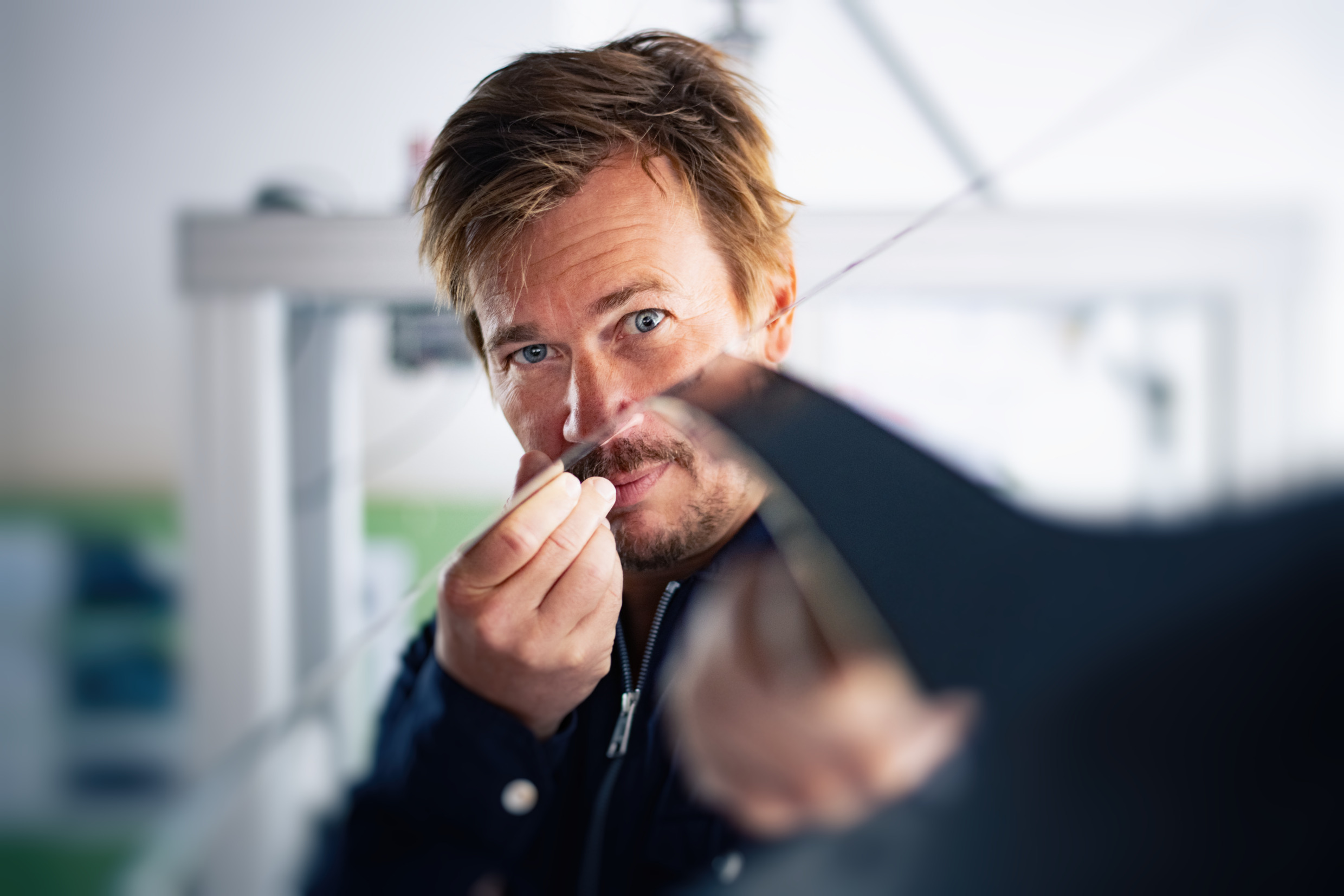 A man examines a piece of metal.